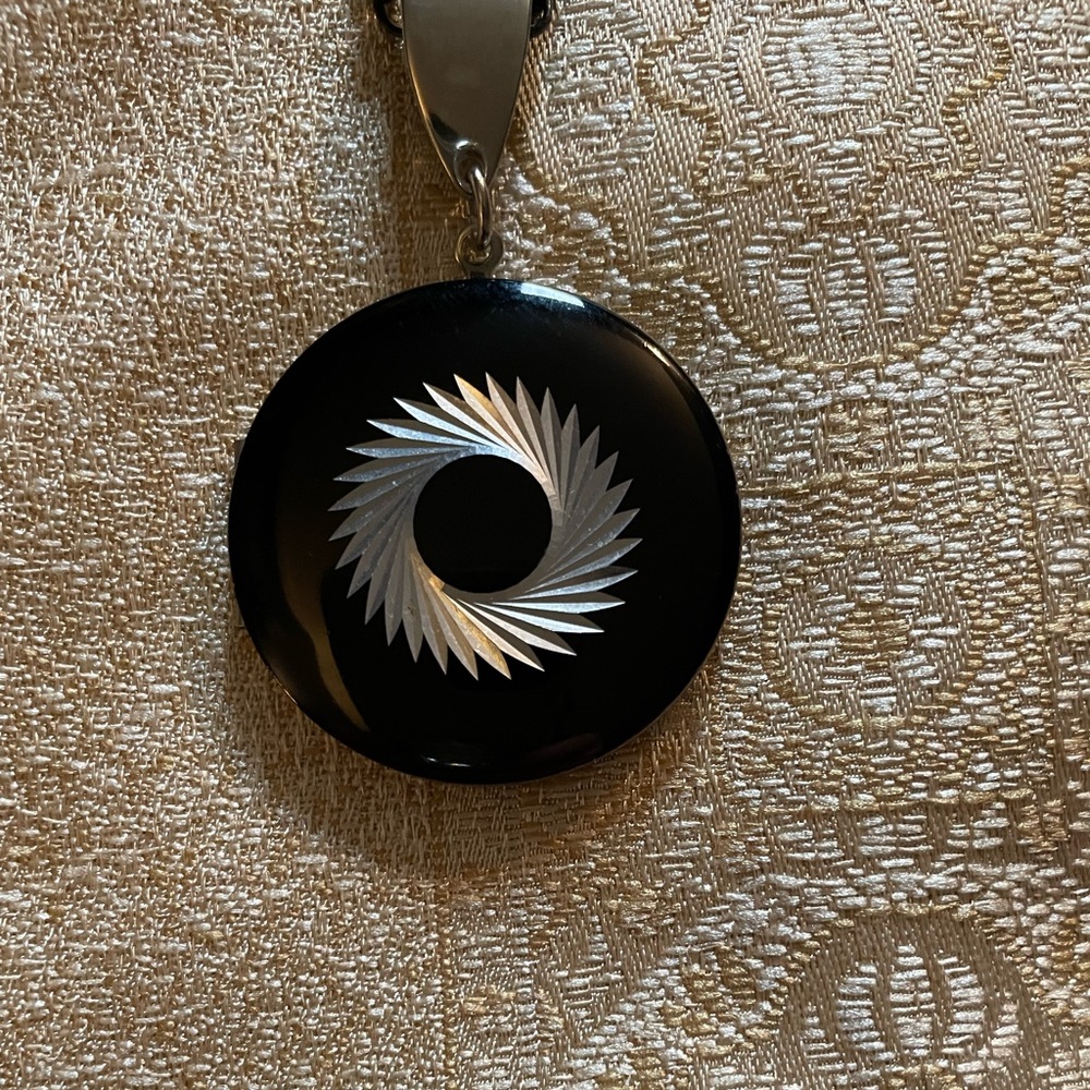 Vintage chrome with black finish locket on chain.